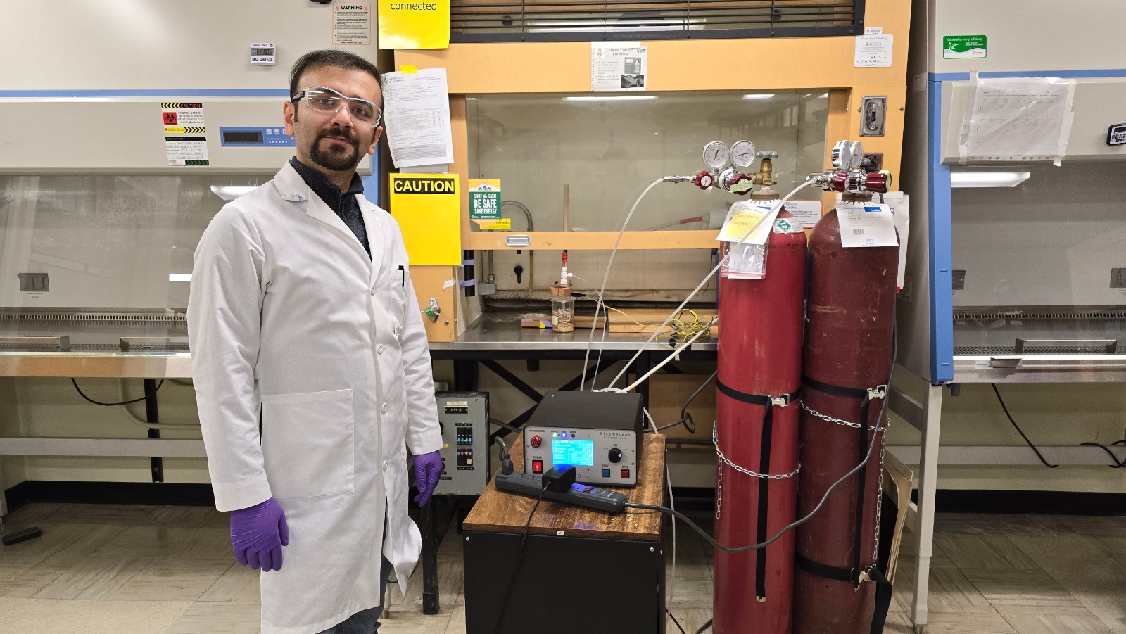 Researcher Ehsan Feizollahi demonstrates the cold plasma steeping technology he and his research team are developing to decontaminate barley. Barley grains are immersed in plasma-activated water in a beaker. (Photo: Supplied)
