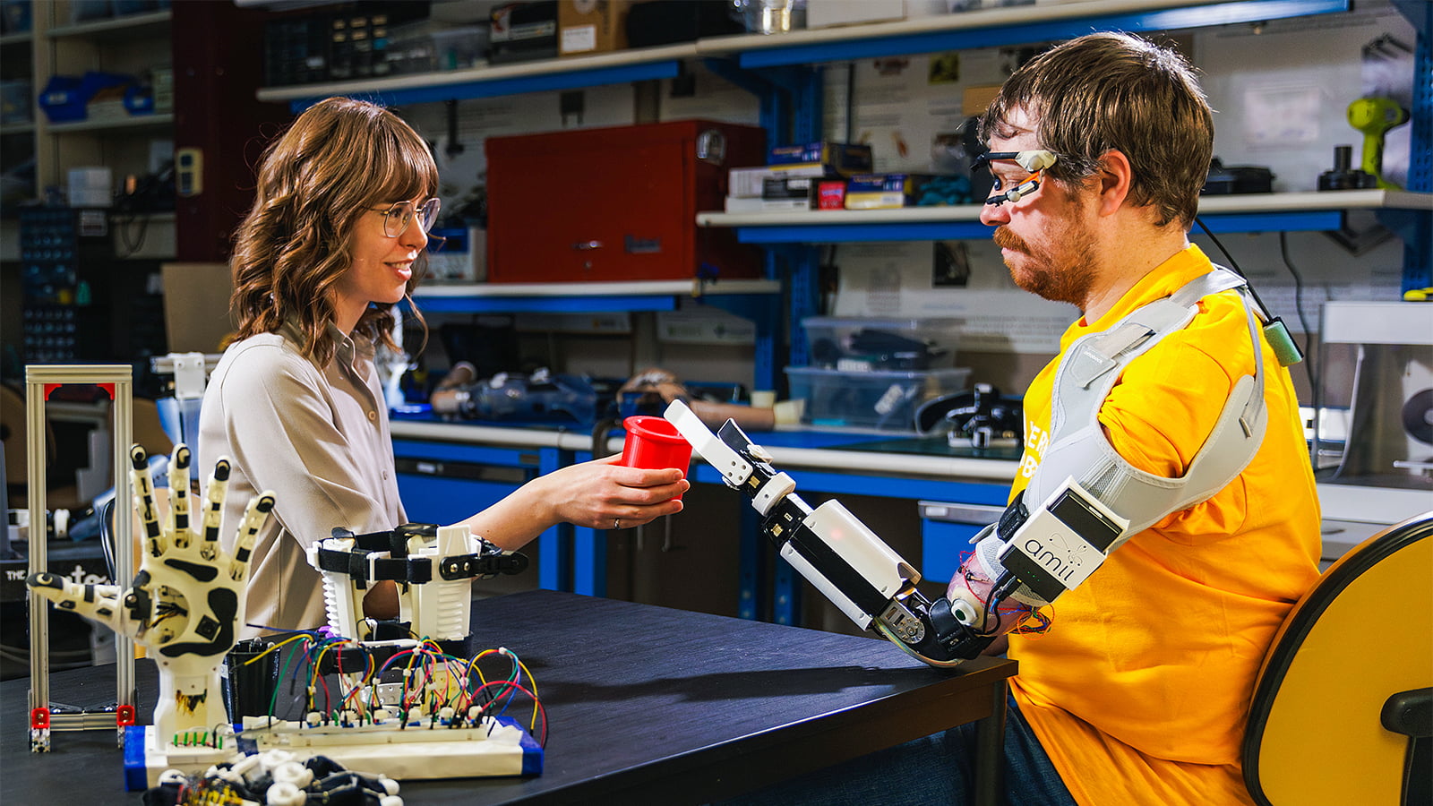Research associate and biomedical engineering graduate Quinn Boser works with a prosthesis user in the Bionic Limbs for Improved Natural Control (BLINC) laboratory at the University of Alberta. (Photo: Alex Pugliese)